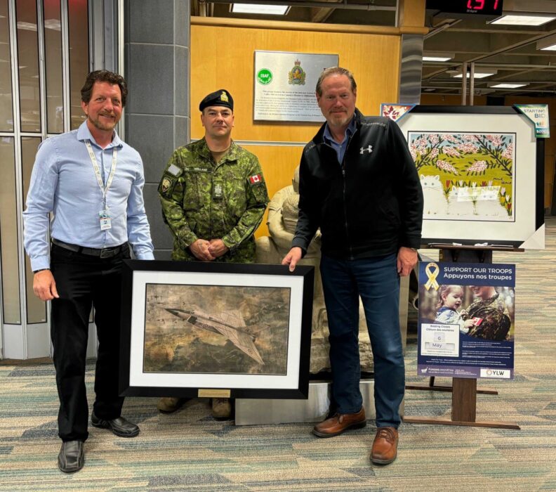 Funding Innovation’s Derek Galenzoki and Chief Warrant Officer Brodie Holland present Neil Drachenburg